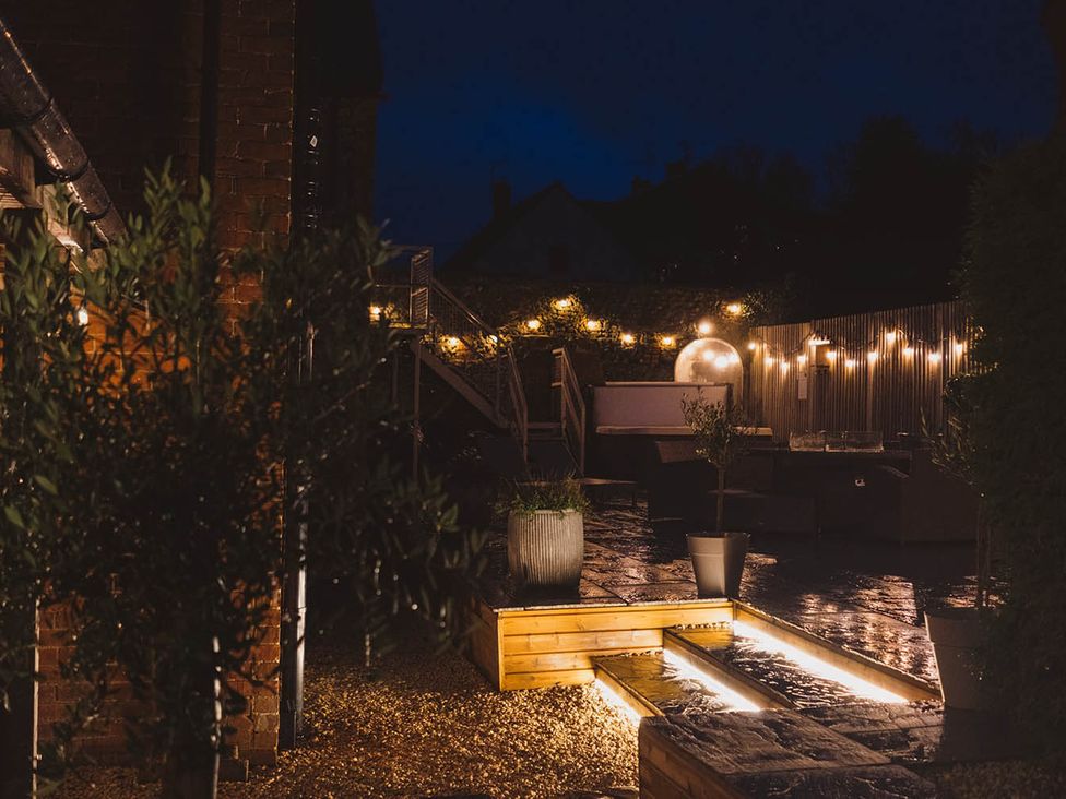 An outdoor area with lighting and planters at the property