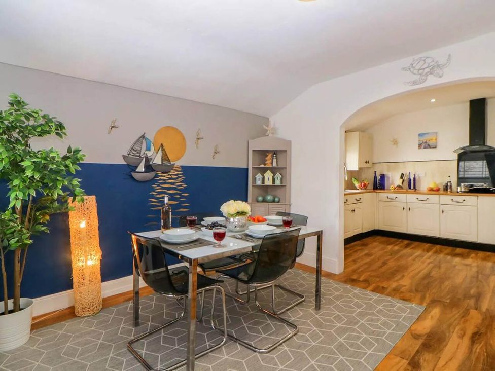 A dining table with chairs and flowers at a home dining room