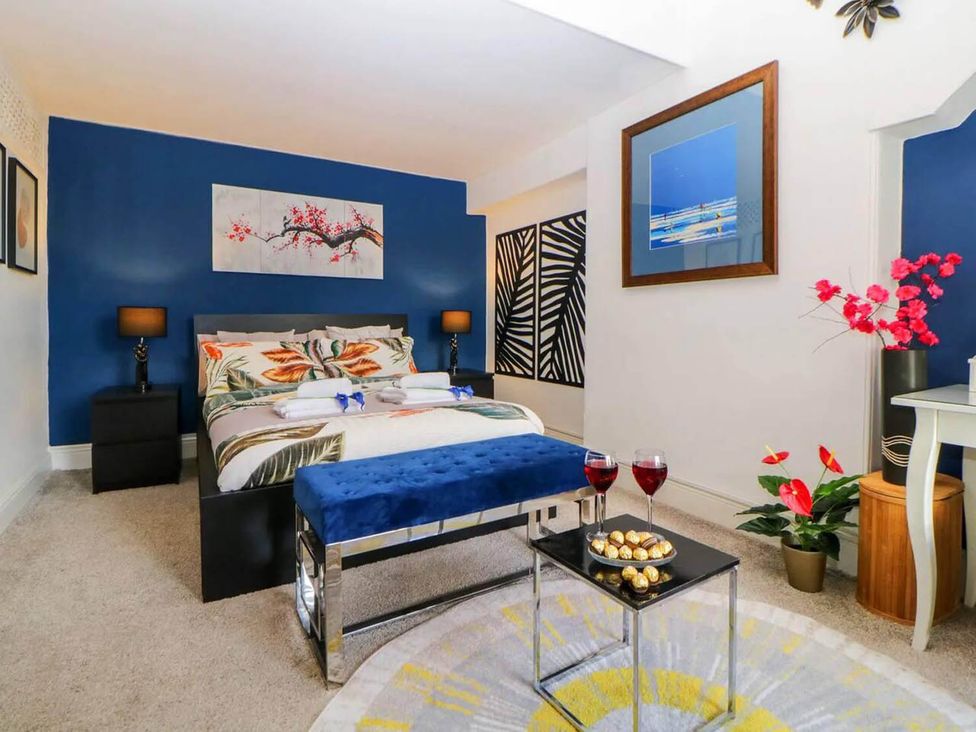 A bedroom with a bed, nightstands, and decorative items at the property in location