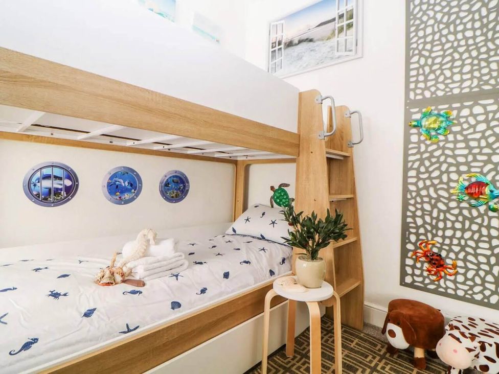 A bunk bed with nautical decor and a plant in a bedroom at The Seaside Retreat in Miami
