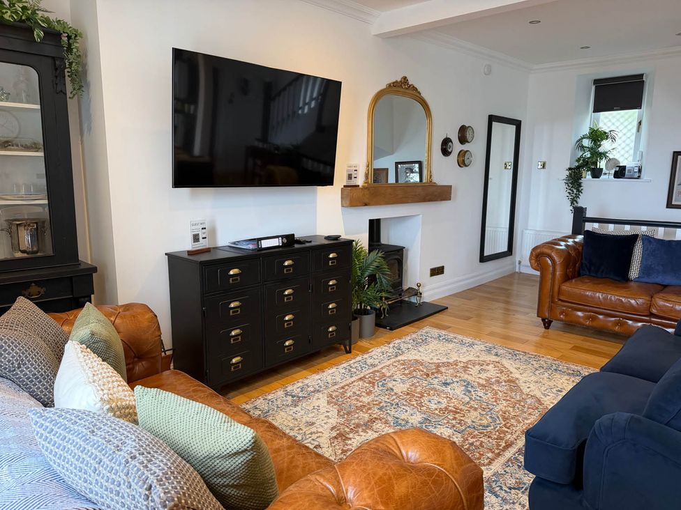 A living room with a television, sofa, and coffee table in a modern setting at 