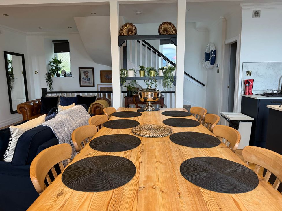 A dining room with a wooden table and chairs at The Old Barn in Manchester