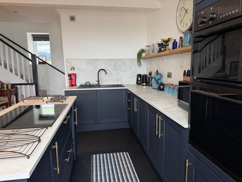 A kitchen with cabinets and appliances at the property in the location