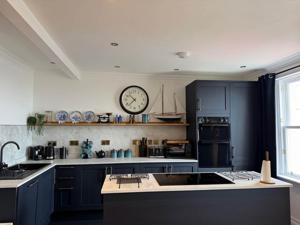 A kitchen with shelves and appliances at 