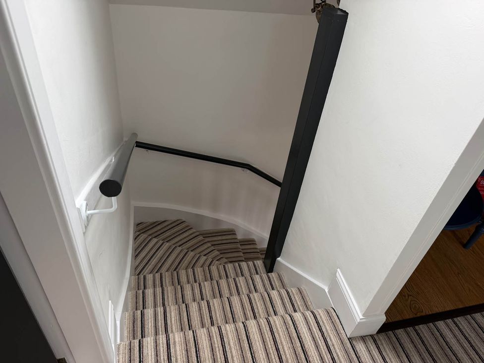 Stairs with handrail and carpet in a stairwell