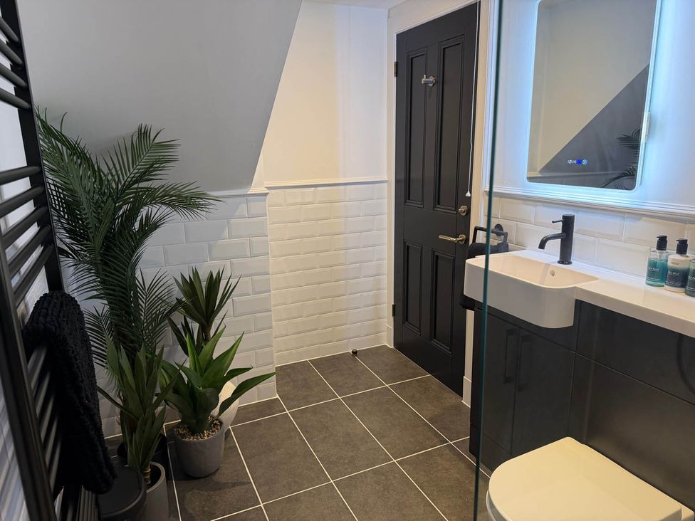 A bathroom with plants and a sink at The Old Barn in Manchester