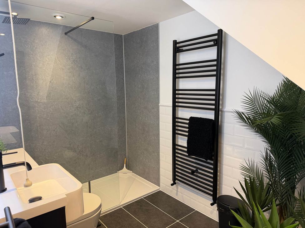 A bathroom with a shower and sink at 