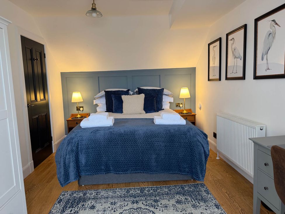 A bedroom with a bed and wall art at The Old Barn in Manchester