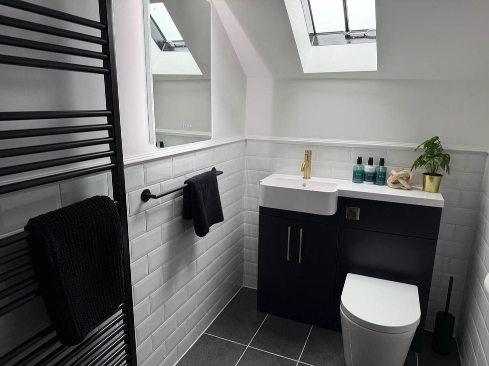 A bathroom with a sink, toilet, and towel rack at 