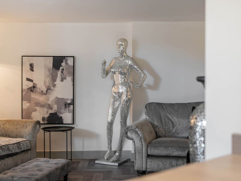 A living room with a mannequin and artwork at Annexe Bungalow Sleeps 2 Maximum Parking Garden in Scratby