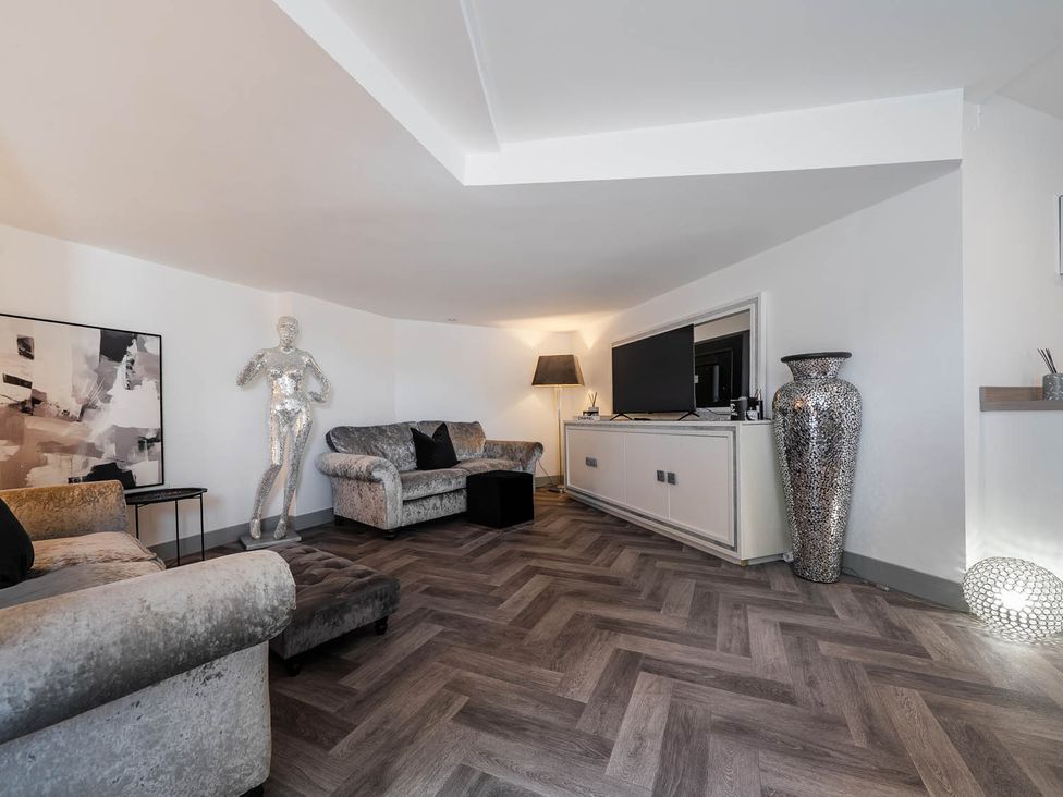 A living room with sofa and television at Annexe Bungalow Sleeps 2 Maximum Parking Garden Scratby