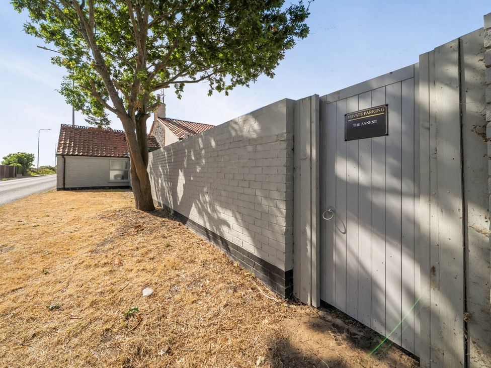 A fence and gate with a private parking sign at Annexe Bungalow Scratby