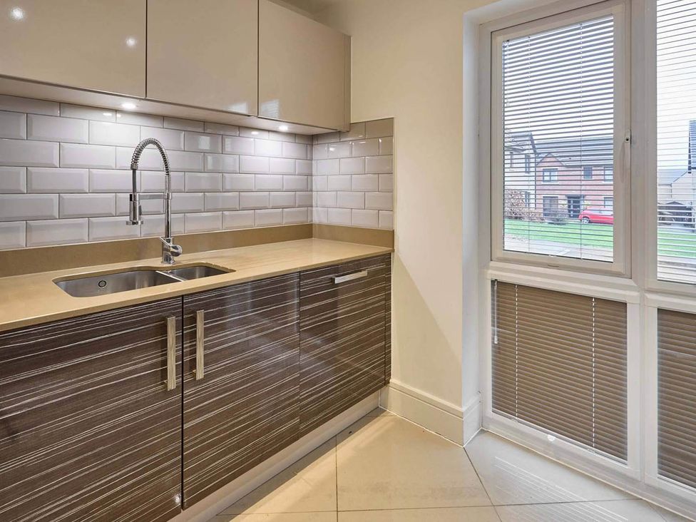 A kitchen with a sink and cabinets at House Sleeps 8 with WiFi in Corby