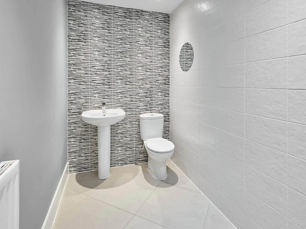 A bathroom with a sink and toilet at House Sleeps 8 with WiFi, Corby