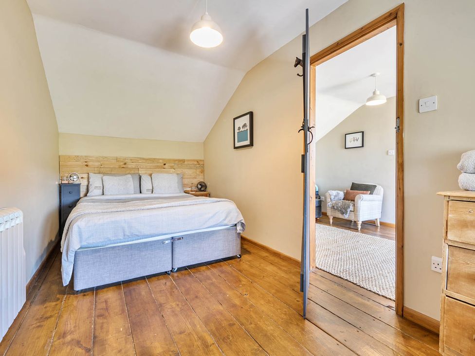 A bedroom with a bed and furniture at Hayloft Sleeps 3 with Enclosed terrace Dereham