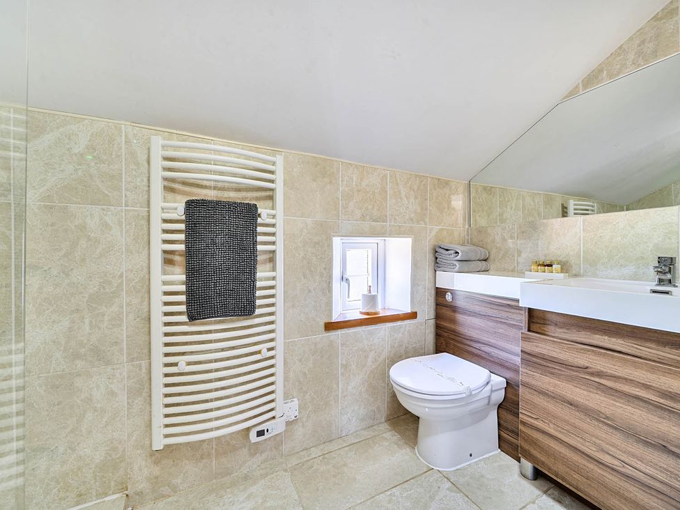 A bathroom with a toilet and sink at Hayloft Sleeps 3 with Enclosed terrace Dereham