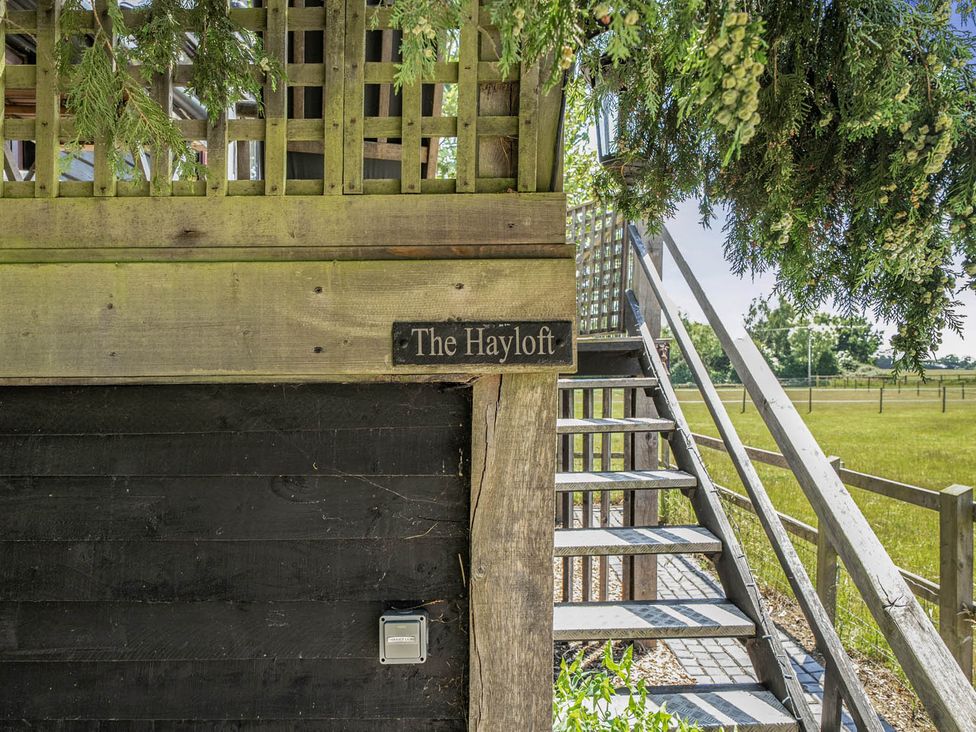 Steps leading to The Hayloft with a wooden sign at Hayloft Sleeps 3 with Enclosed terrace Dereham