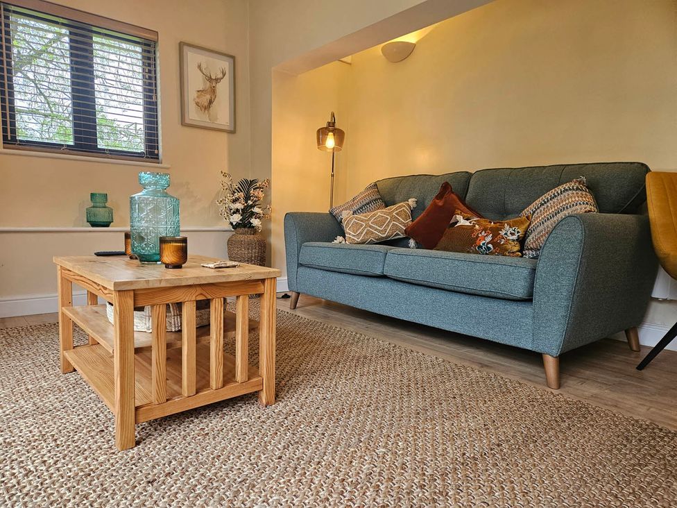 A living room with a sofa and coffee table at Lily's Cottage Suffolk Sleeps 2 with Pets, Mendlesham Green near Stowmarket