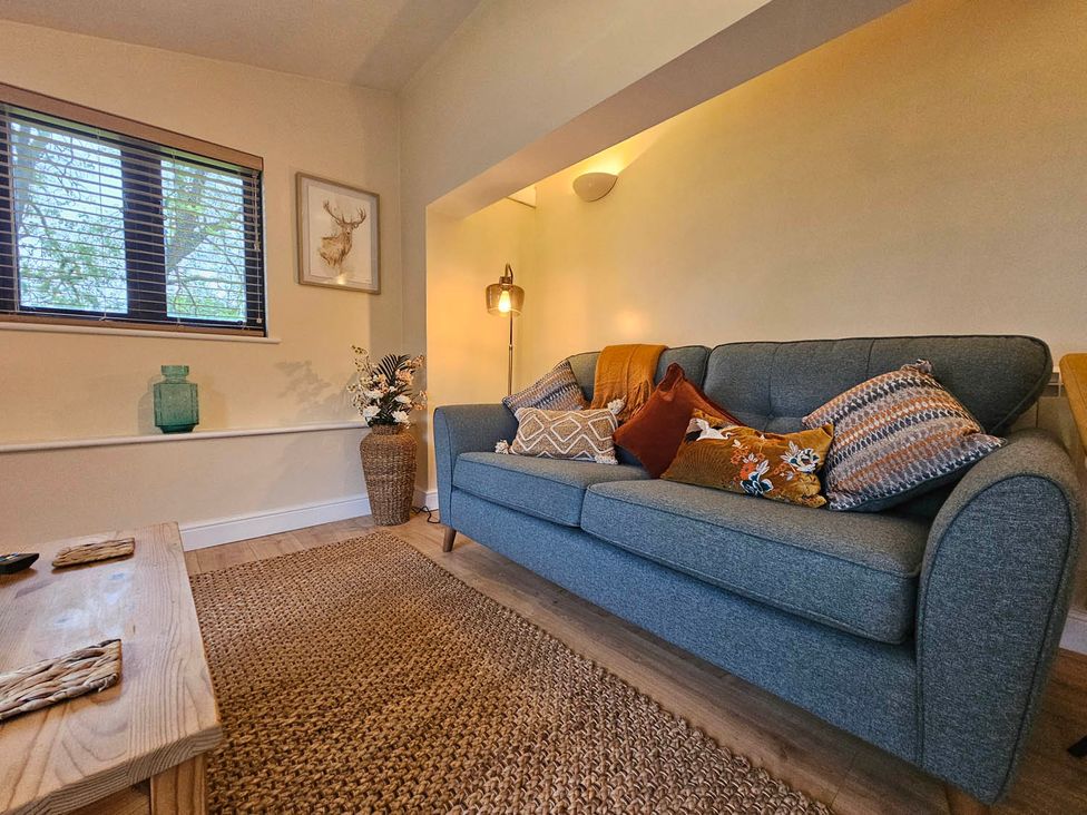 A living room with a sofa and decorative items at Lily's Cottage Suffolk Sleeps 2 with Pets Mendlesham Green near Stowmarket