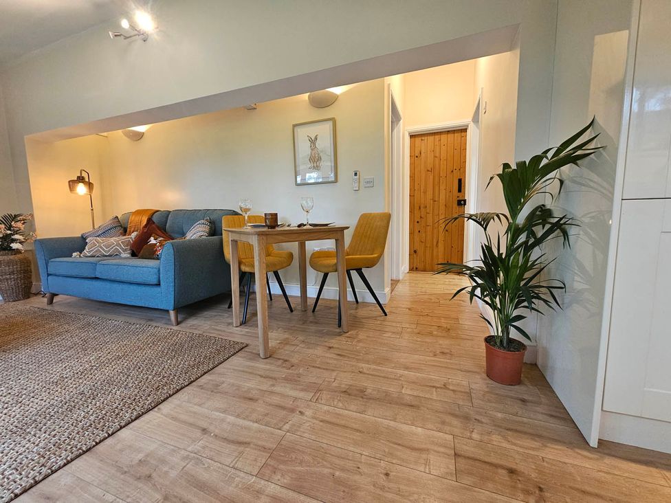 A living room with a sofa and dining area at Lily's Cottage Suffolk Sleeps 2 with Pets Mendlesham Green near Stowmarket