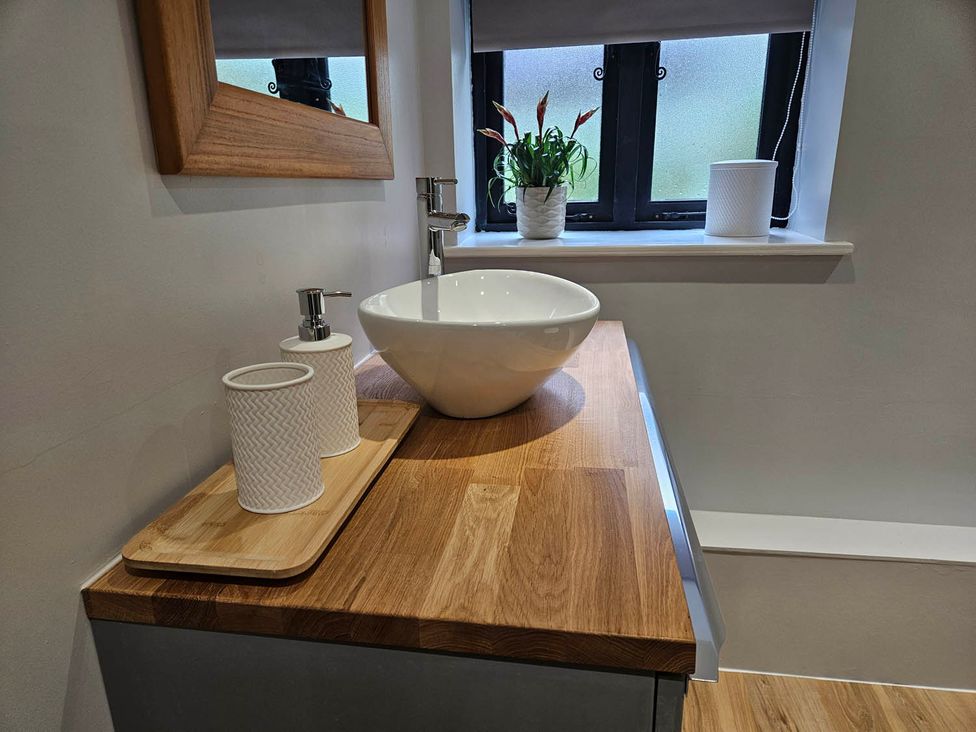 A bathroom with a sink and mirror at Lily's Cottage Suffolk Sleeps 2 with Pets near Mendlesham Green