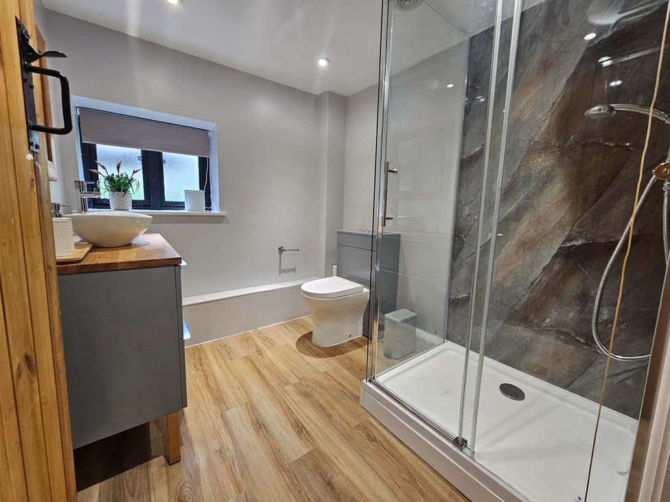 A bathroom featuring a shower, toilet, and sink at Lily's Cottage Suffolk Sleeps 2 with Pets, Mendlesham Green near Stowmarket