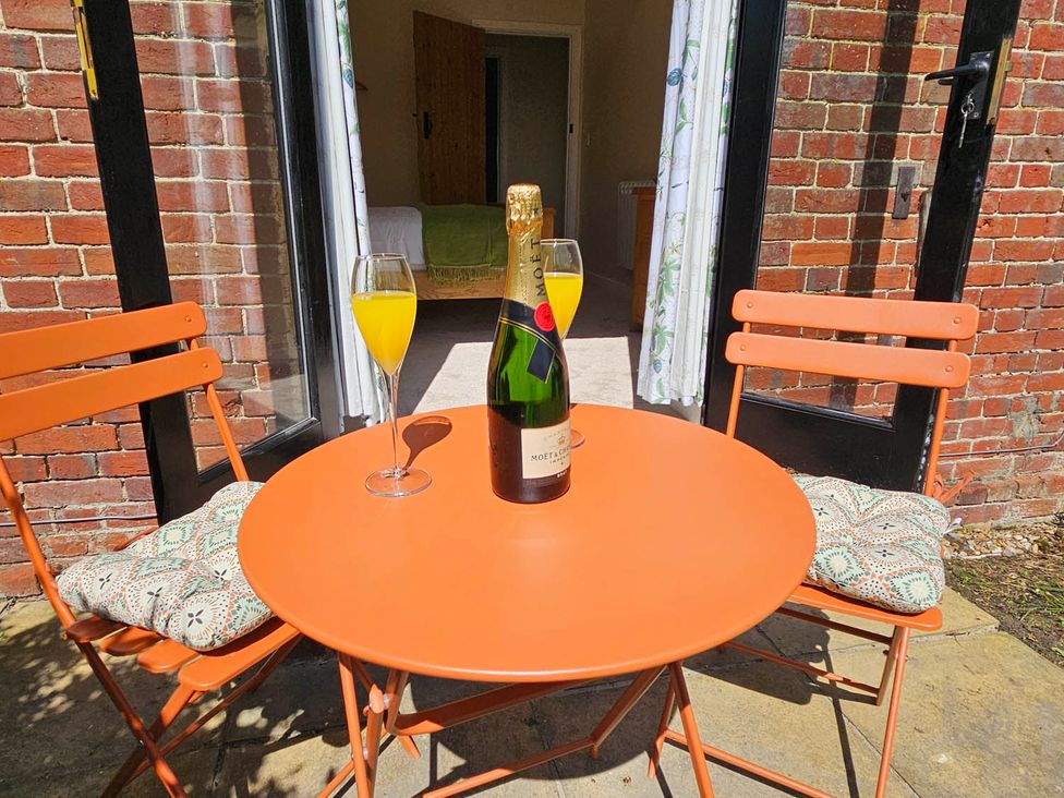 A table with a champagne bottle and drinks at Lily's Cottage Suffolk Sleeps 2 with Pets in Mendlesham Green near Stowmarket