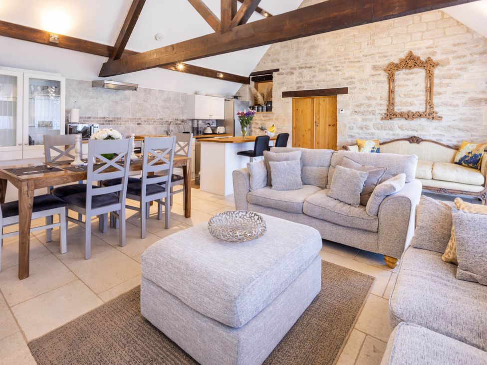A living room with a couch and dining table at The Dovecote 3Bed Cottage Rowden Manor in Chippenham