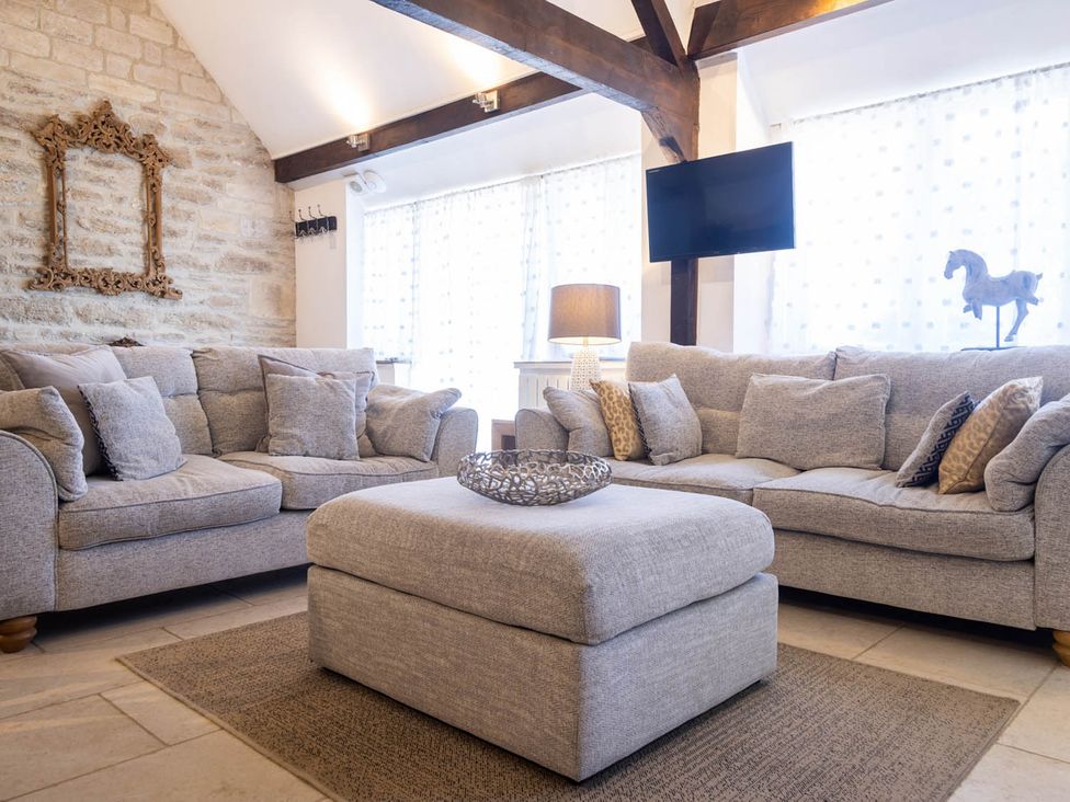 A living room with sofas and an ottoman at The Dovecote 3Bed Cottage Rowden Manor in Chippenham