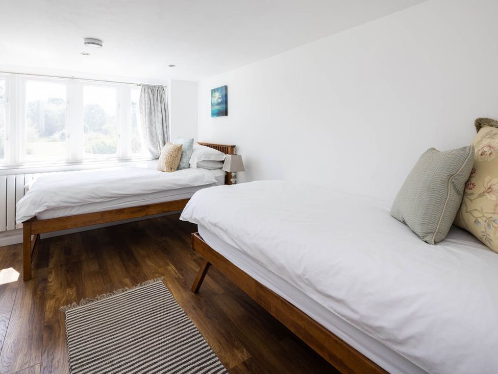 A bedroom with two beds and a window at The Dovecote 3Bed Cottage Rowden Manor in Chippenham