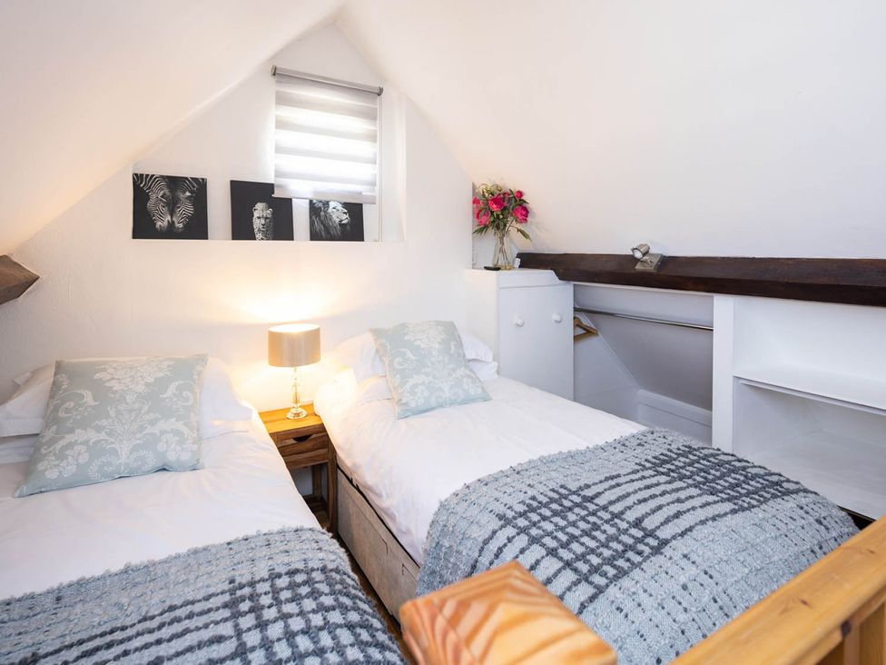 A bedroom with two beds and wall art at The Dovecote 3Bed Cottage Rowden Manor Chippenham