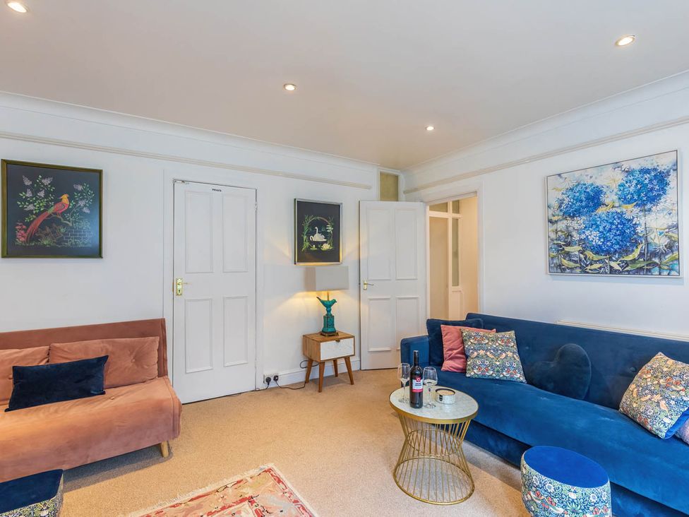 A living room with a sofa and coffee table at Seafront Apartment Private Garden Free Parking in Littlehampton