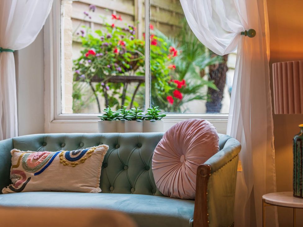 A living room with a sofa and window at Seafront Apartment Private Garden Free Parking Littlehampton