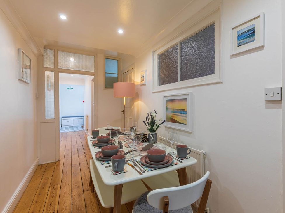 A dining room with a table set for dinner at Seafront Apartment Private Garden Free Parking Littlehampton