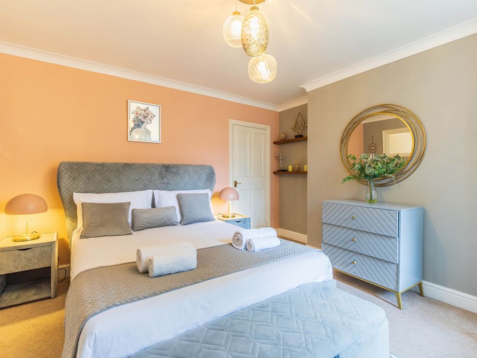 A bedroom with a bed and bedside lamps at Seafront Apartment Private Garden Free Parking Littlehampton