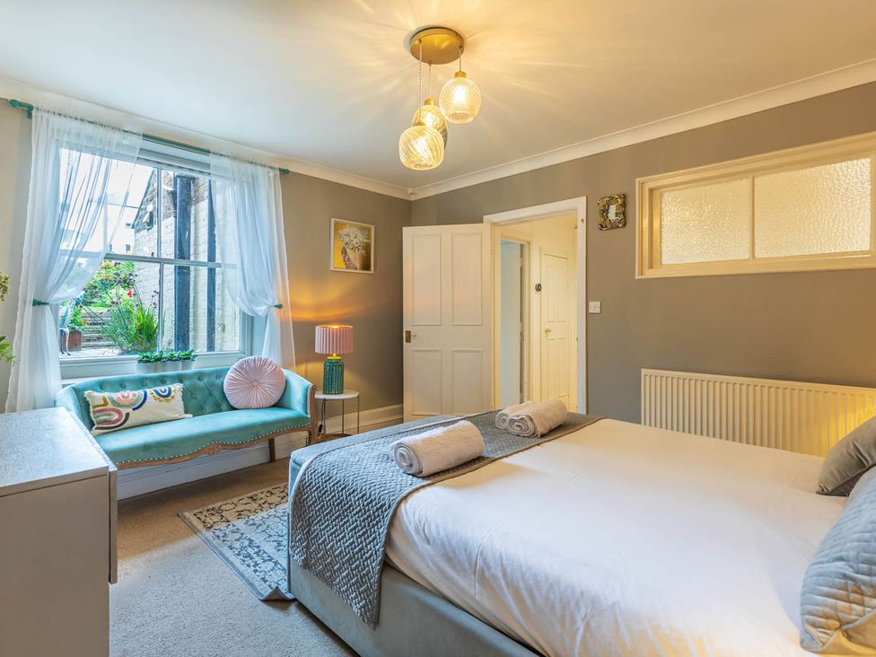 A bedroom with a bed and a sofa at Seafront Apartment Private Garden Free Parking in Littlehampton