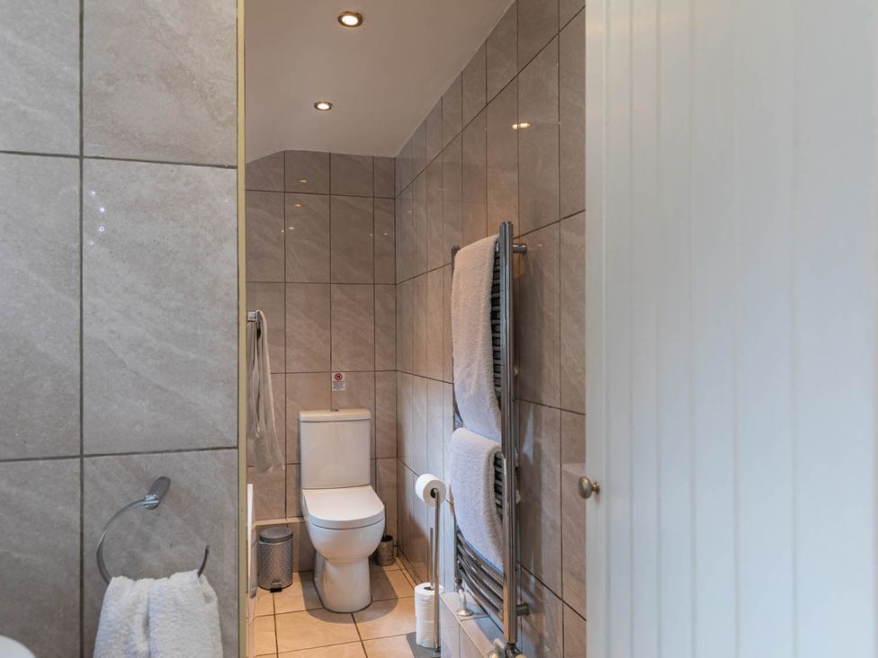 A bathroom with a toilet and towel rail at Seafront Apartment Private Garden Free Parking Littlehampton