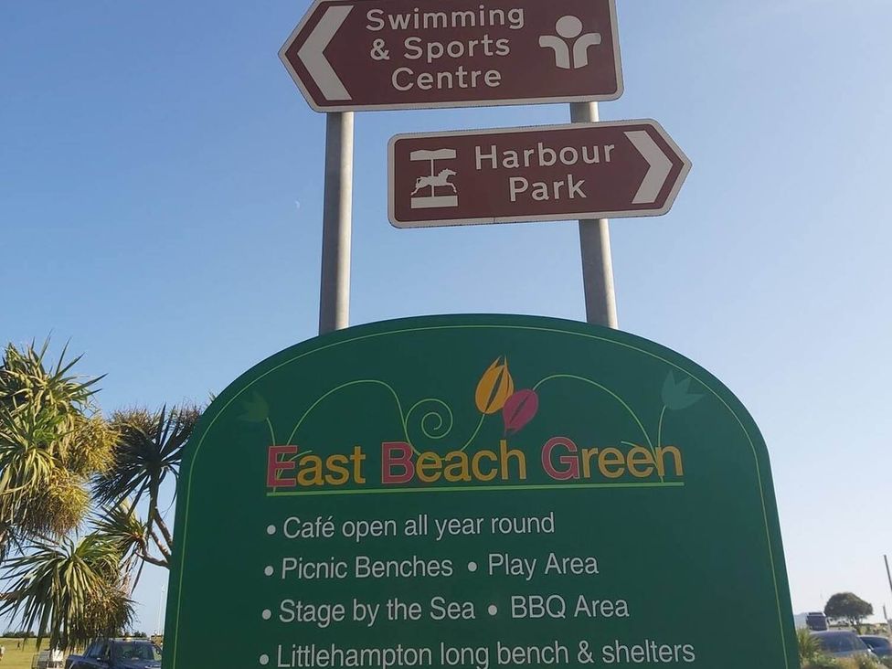 A sign for East Beach Green with amenities listed in Littlehampton