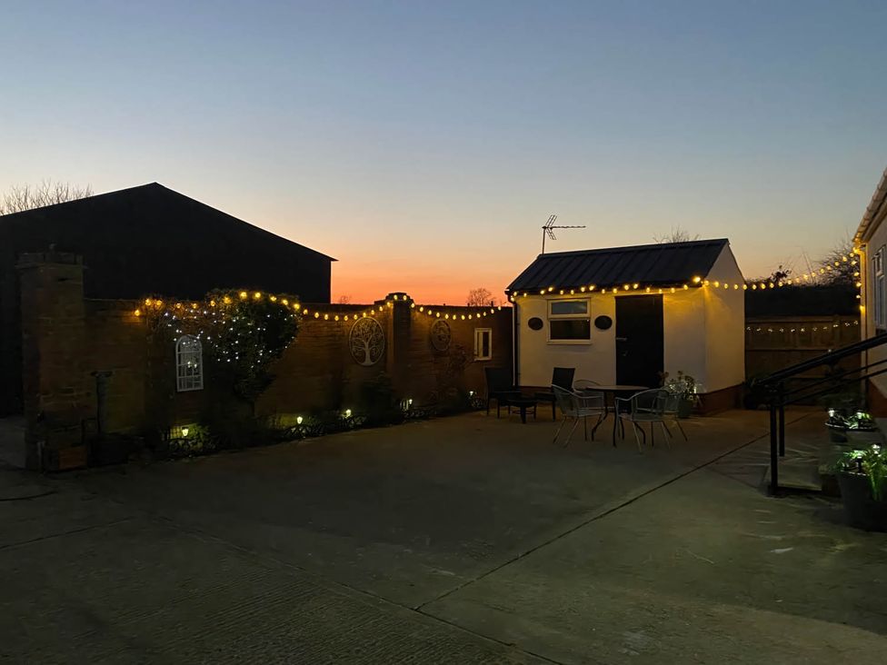 An outdoor area with lights and furniture at Paddock View Snetterton Norfolk near East Harling