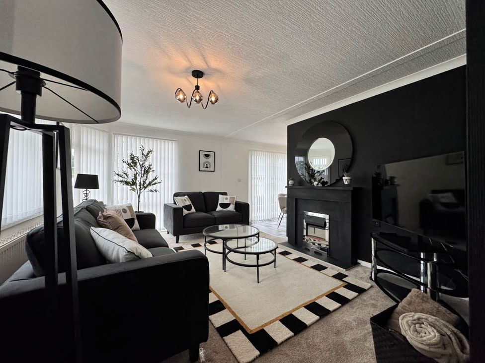 A living room with a coffee table and a television at Paddock View Snetterton Norfolk near East Harling