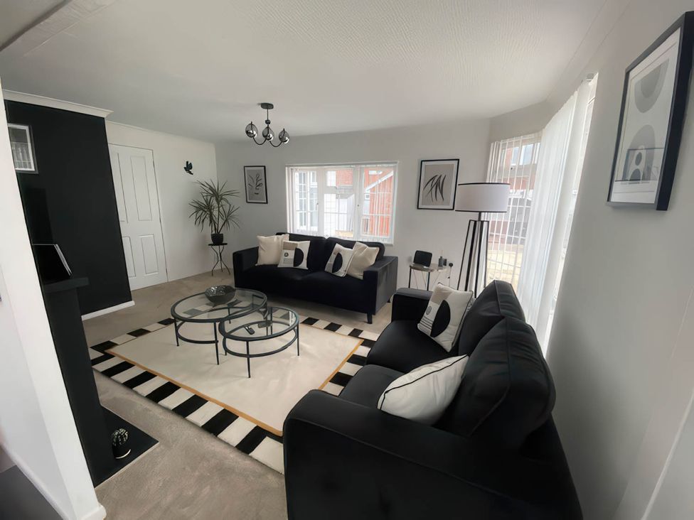 A living room with a sofa and table at Paddock View Snetterton Norfolk Near East Harling