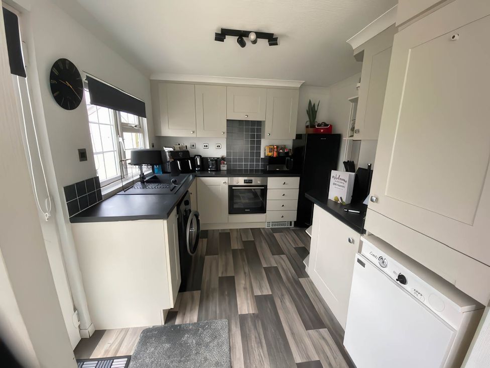 A kitchen with appliances and cabinets at Paddock View Snetterton Norfolk Near East Harling