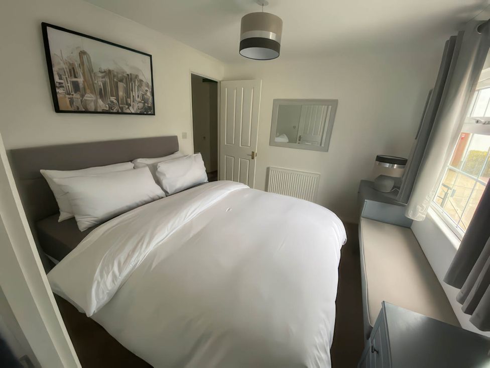 A bedroom with a bed and a desk at Paddock View Snetterton Norfolk near East Harling