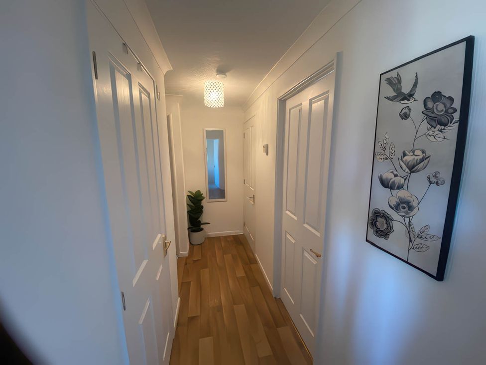 A hallway with a mirror and plant at Paddock View Snetterton Norfolk near East Harling
