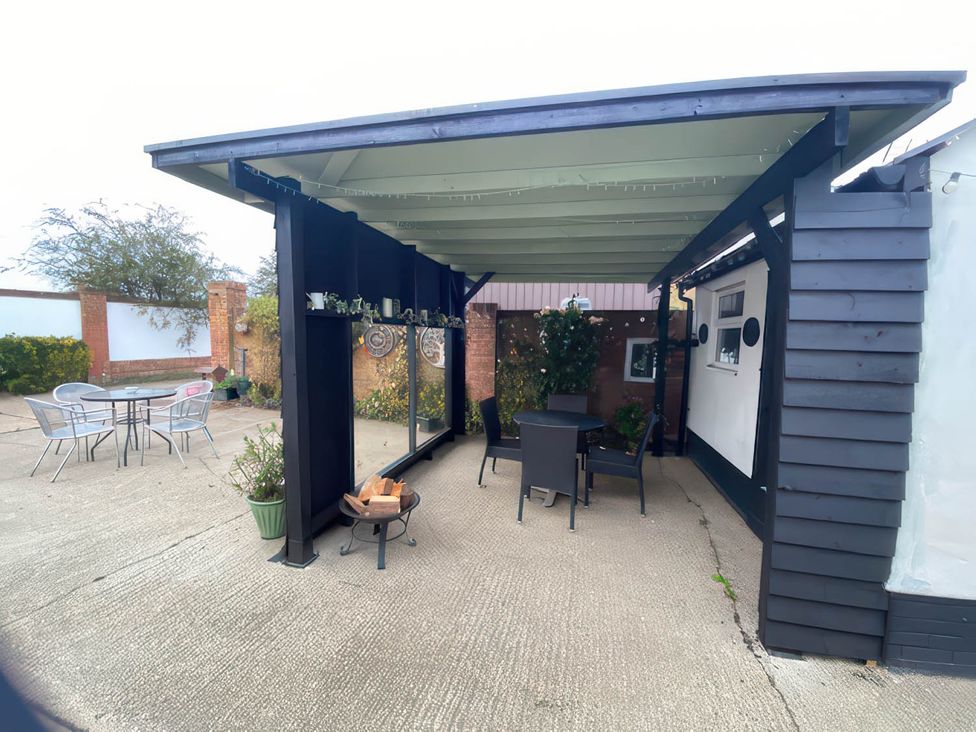 An outdoor patio with a table and chairs at Paddock View Snetterton Norfolk near East Harling