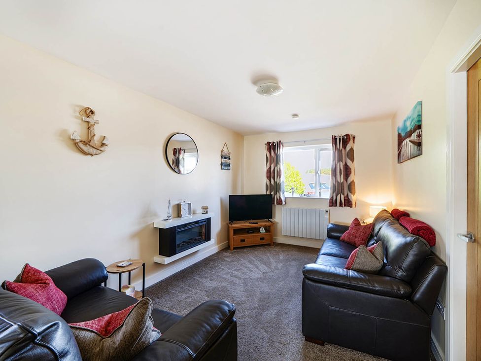 A living room with a television and sofa at Seaside Chalet Retreat in Bridlington