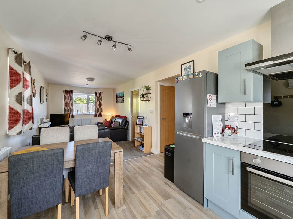 A kitchen and dining area with a dining table and chairs at Seaside Chalet Retreat in Bridlington