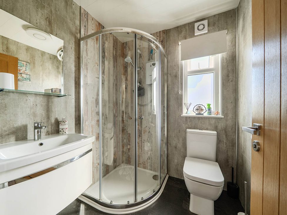 A bathroom with a shower and toilet at Seaside Chalet Retreat in Bridlington