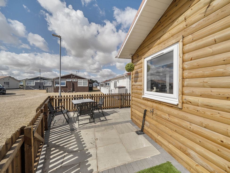 An outdoor area with a table and chairs at Seaside Chalet Retreat in Bridlington