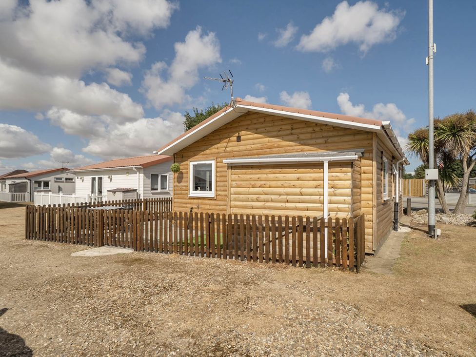 A wooden cabin with a fence at Seaside Chalet Retreat in Bridlington